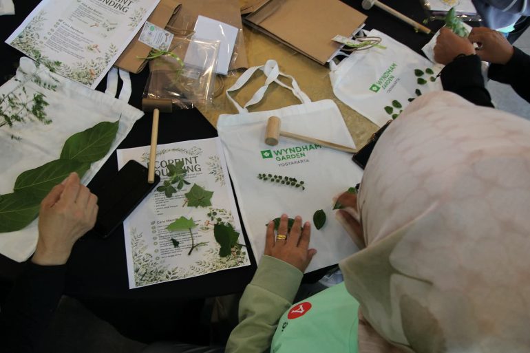 Praktik menyusun daun untuk ecoprint di Wyndham Garden Yogyakarta